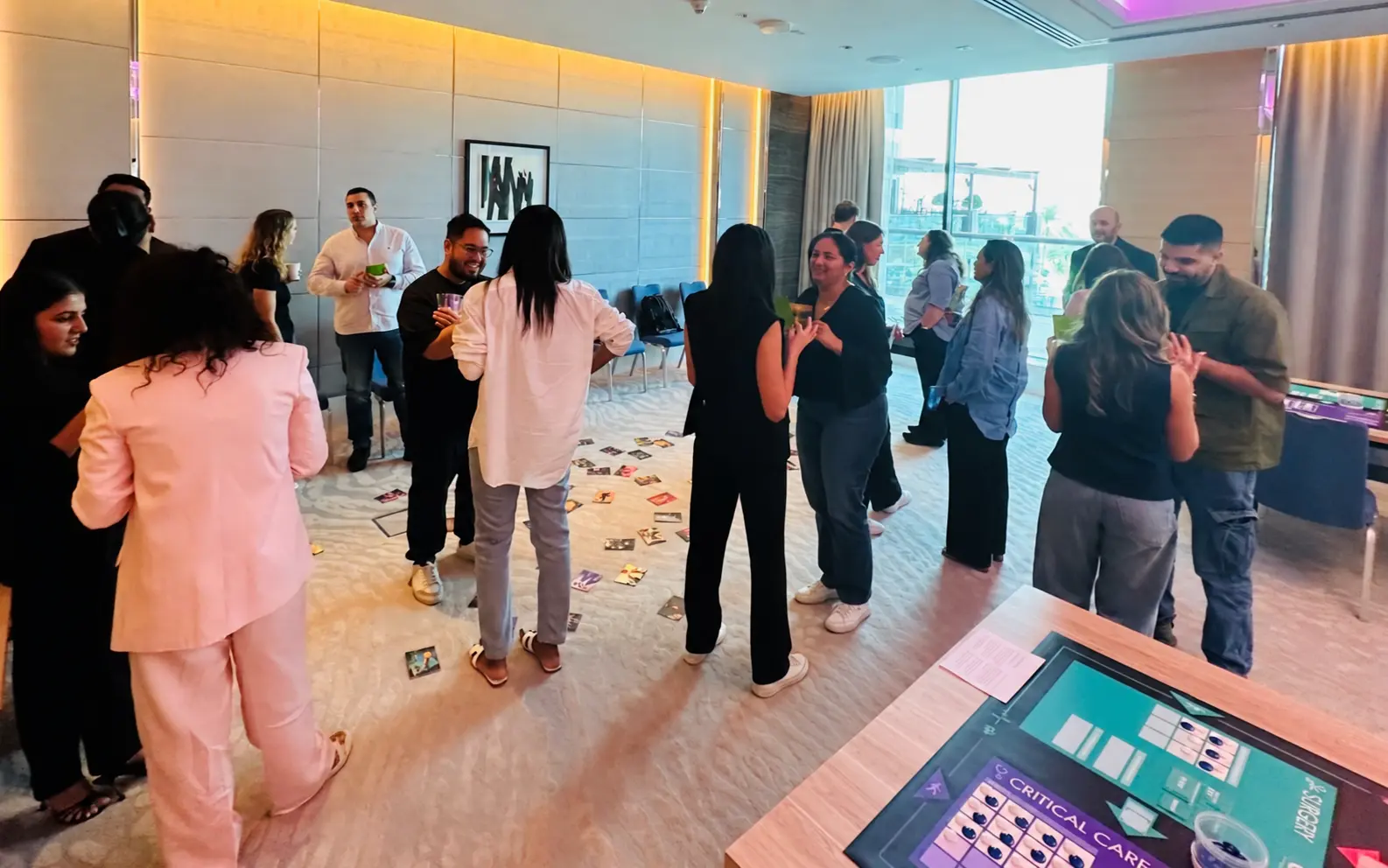 Workshop participants standing in pairs, exchanging ideas and talking together.